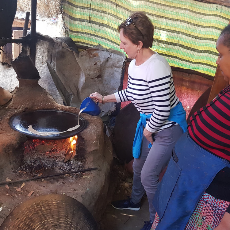 Visitor baking Enjera Bread in Addis Ababa City Tour